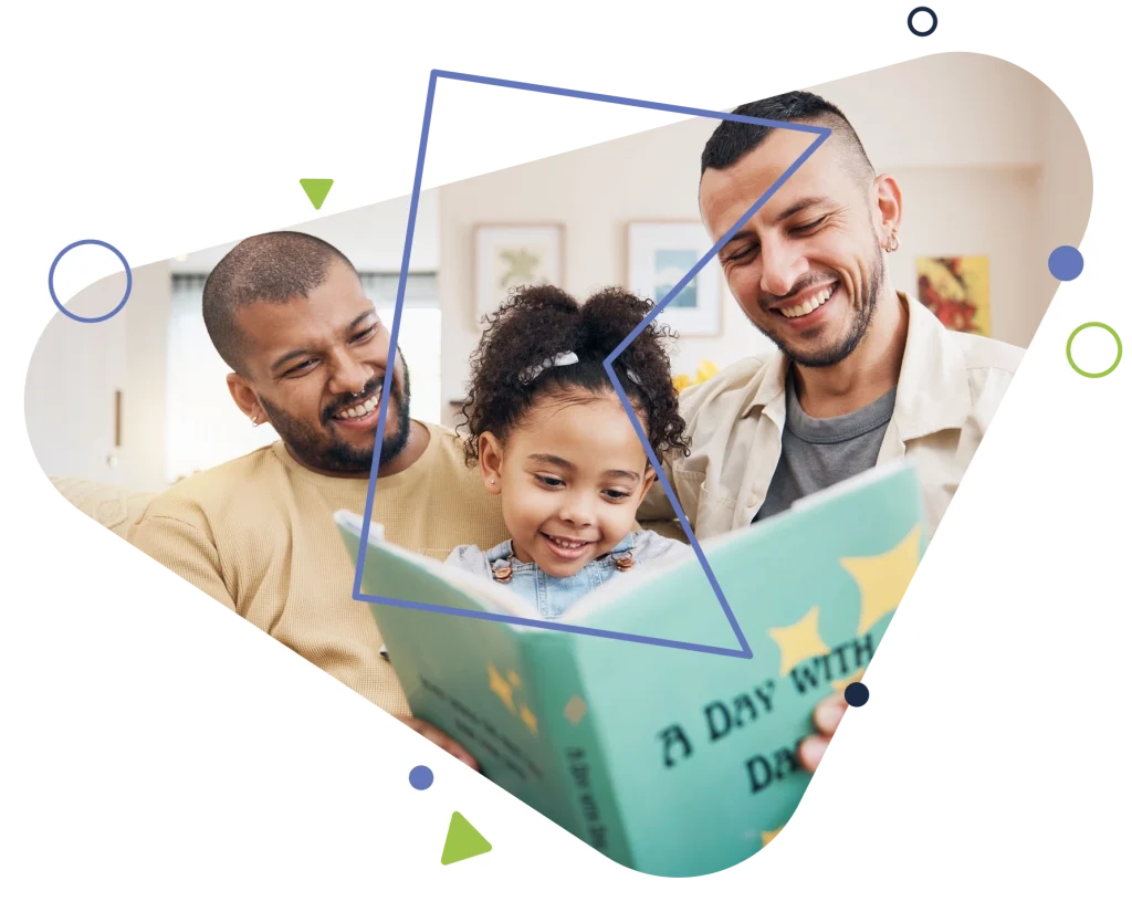 two male foster carers and a child reading a bedtime story